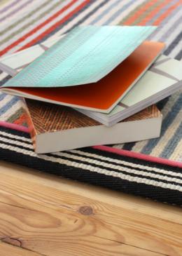 Margo Selby Make Me A Rug: Margo Selby Stripe Frolic Westbrook (1921) with Stripes Thick Borders Black (6203) outer and Cotton Borders Pink (1030) inner border (Double piping) lifestyle shot 2 